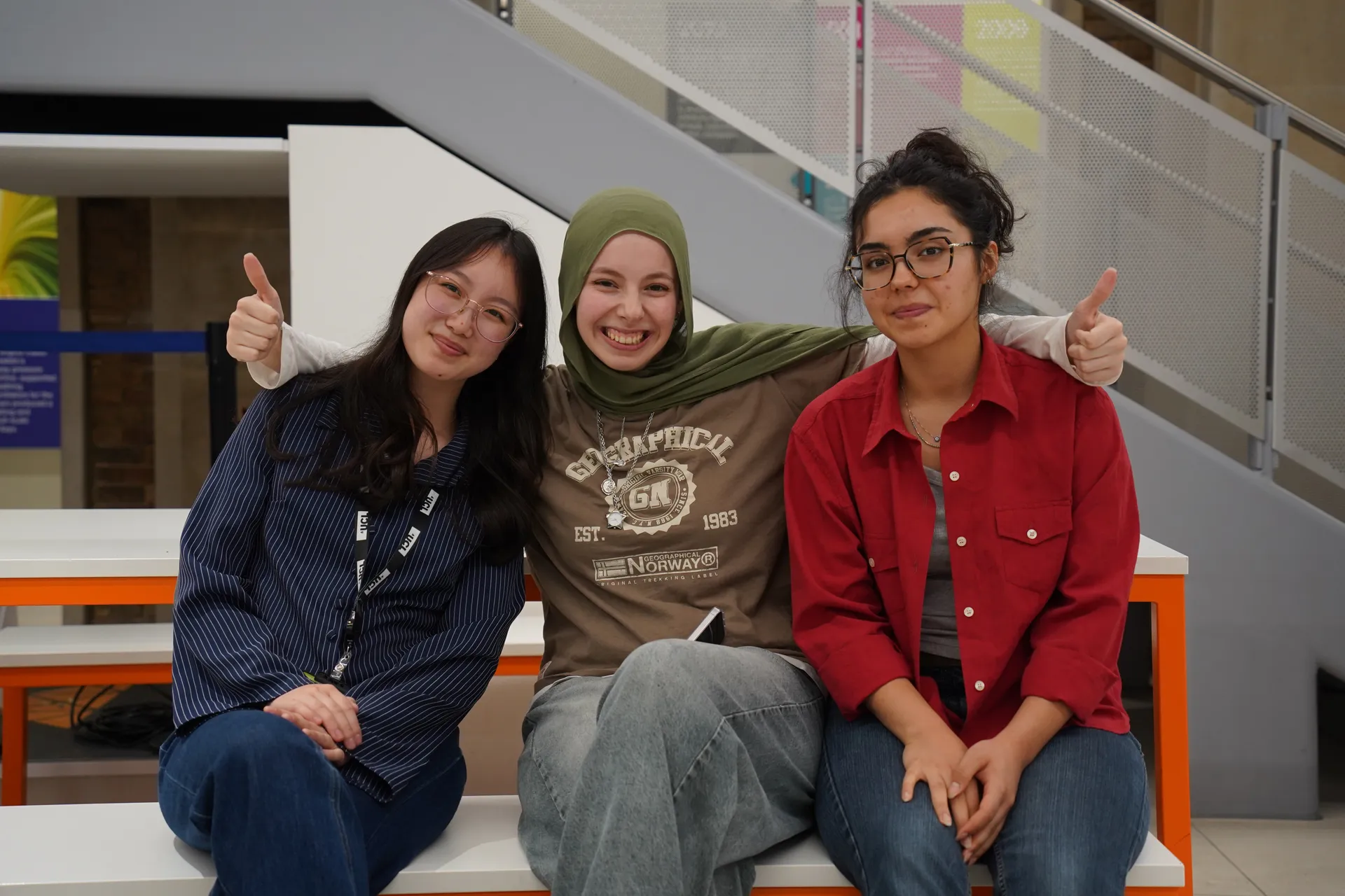 Three summer school students smiling together at University College London