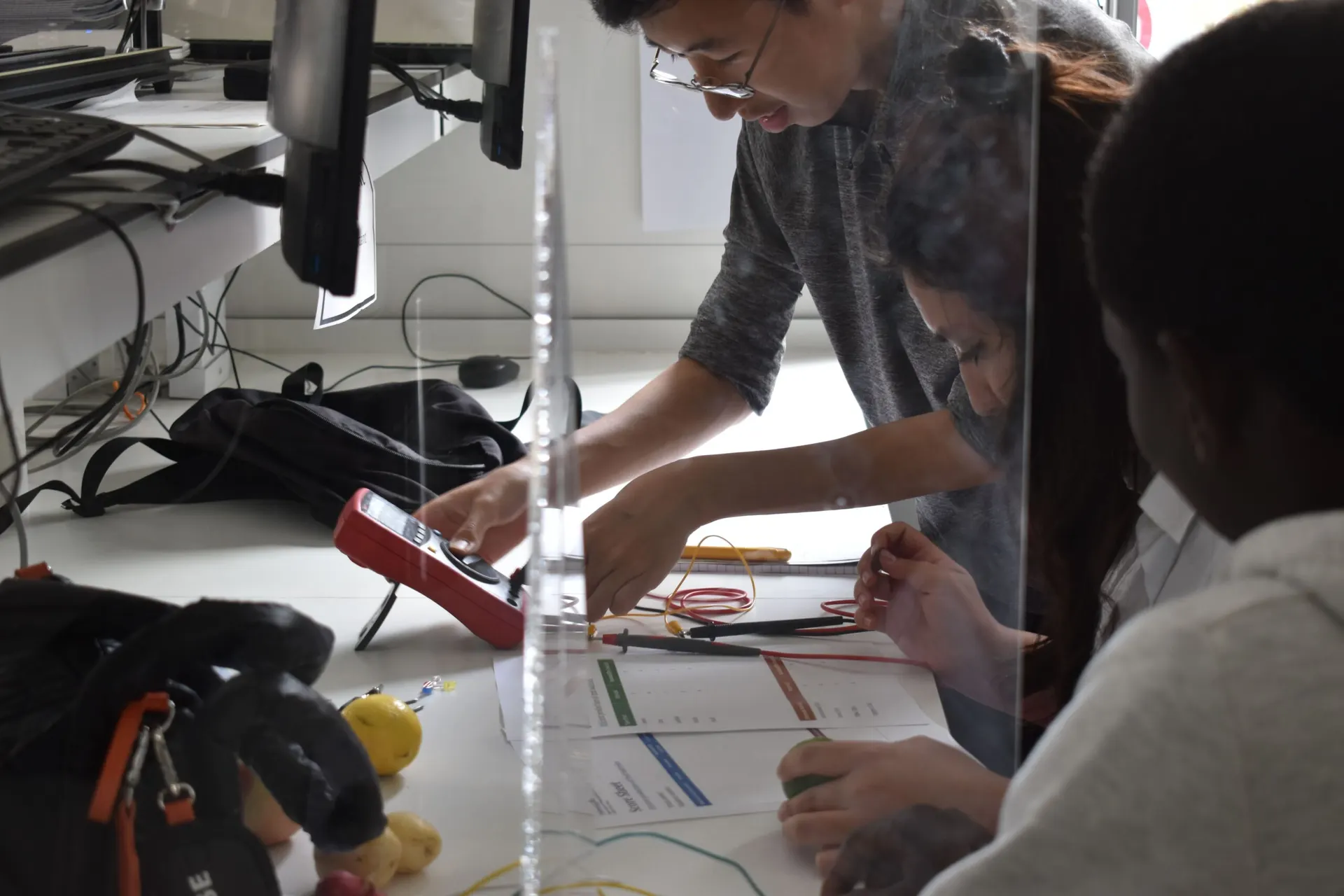 Volunteers running a practical workshop with summer school students