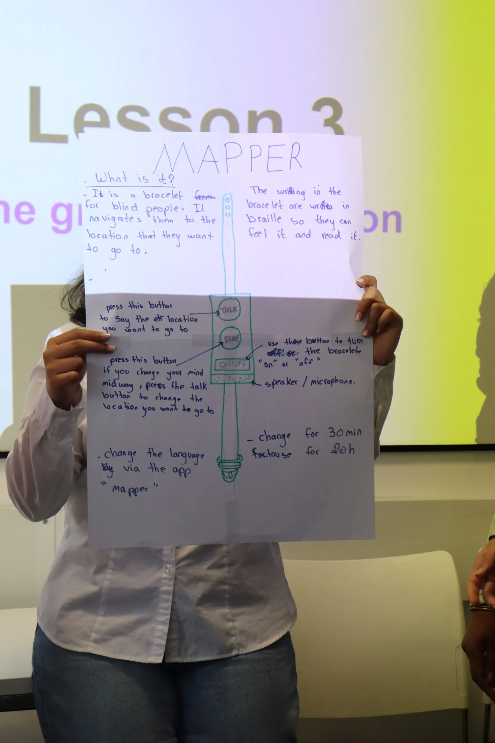 A summer school student holding up the academic poster they produced during the programme